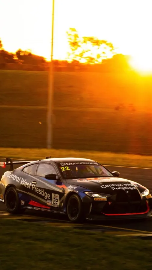 The #22 Central West Prestige BMW M4 GT4 on track at sunset